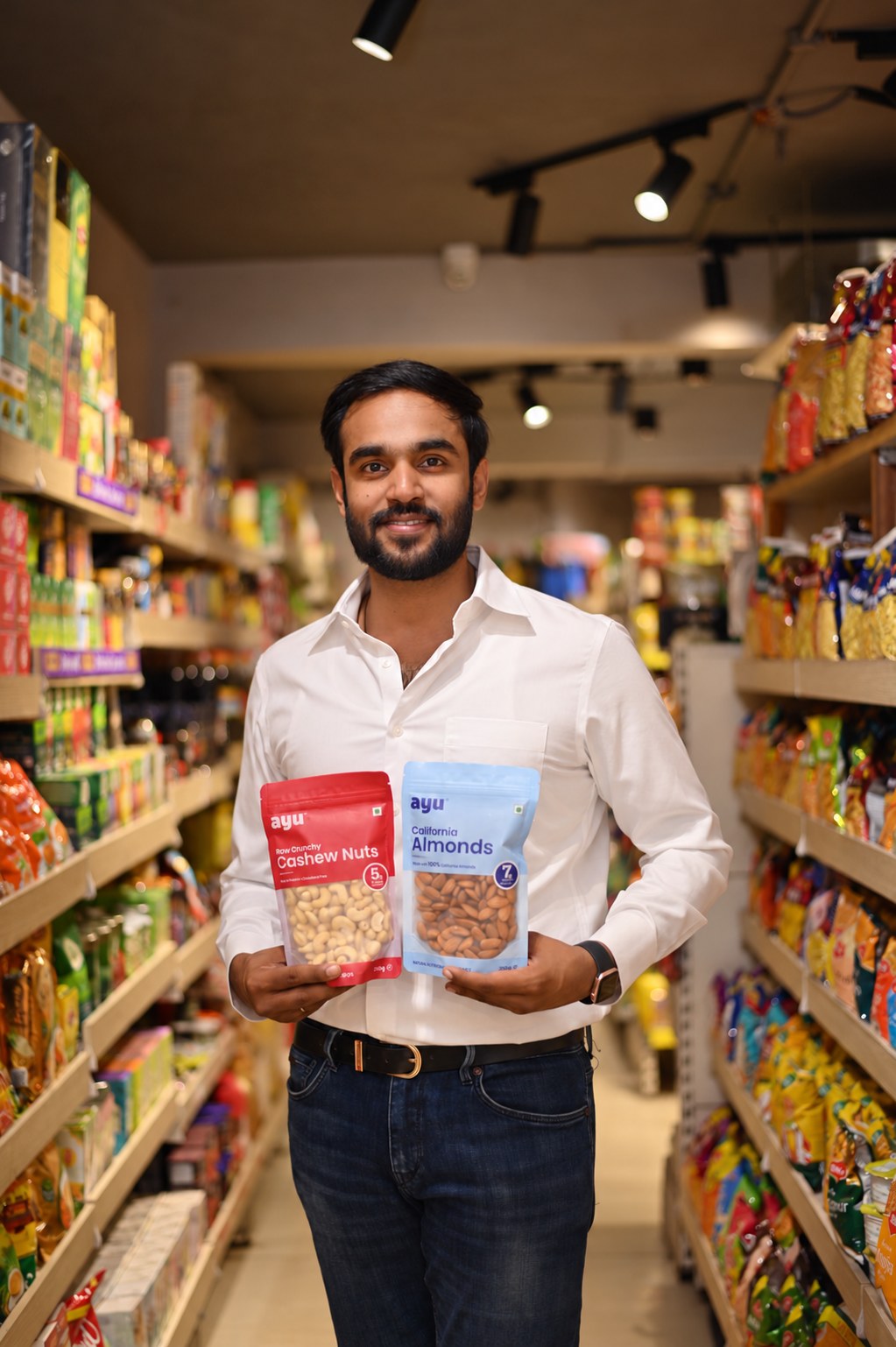 Ayu Superfoods cashew and almond packs held up in the Any Minute store